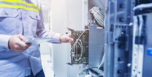 Technician performing maintenance on server equipment inside a data center.
